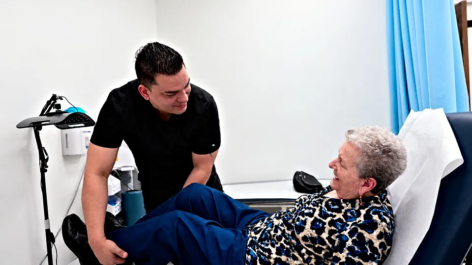 Our physical therapist talking with a patient in the treatment room