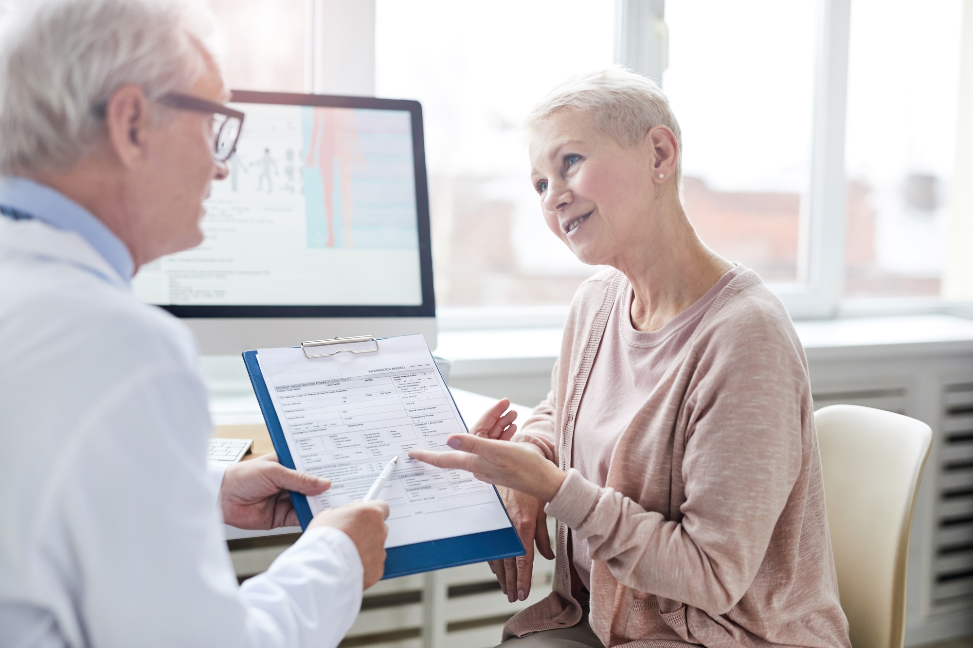 Senior patient asking doctor questions