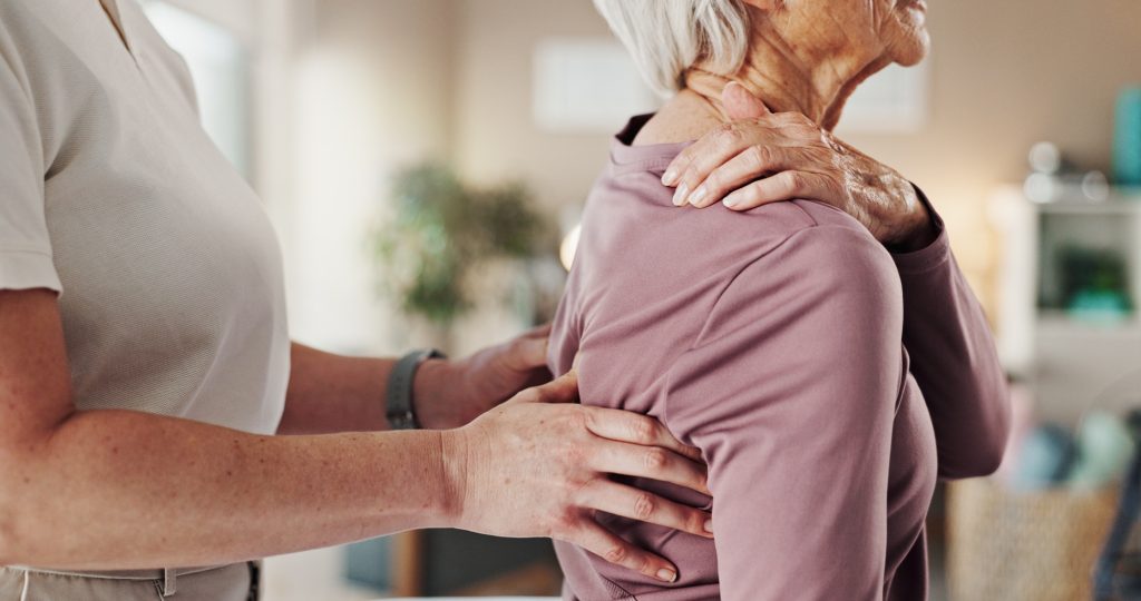 Physiotherapy, hands and healthcare with old woman and back pain for helping, medical and arthritis