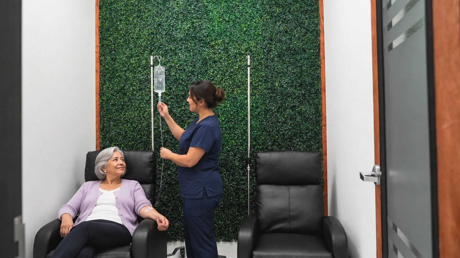 Ozone Therapy in Broward County: What It Is, What We Know, and What to Ask 1 Photo illustration in the real IV therapy room at Metropolitan Medical Centers in Tamarac: an older woman relaxes in a black recliner while a nurse checks the drip, in front of the green plant wall