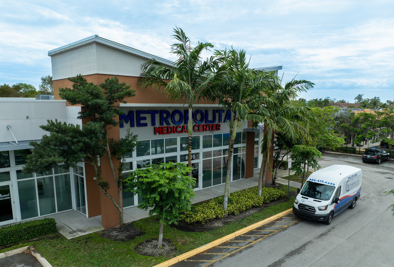 Metropolitan Medical Centers building on N University Drive in Tamarac, Florida, with the free patient transportation van