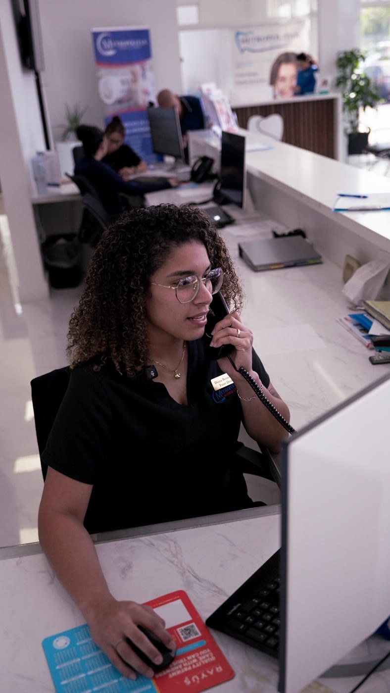 A Metropolitan Medical Centers front-desk team member helping a patient by phone